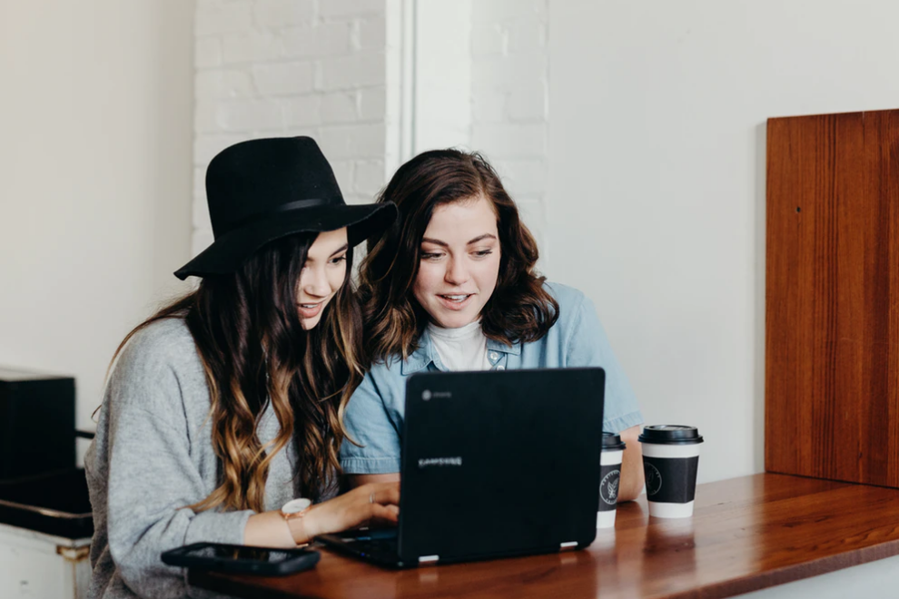 two women in front of laptop, scholarships and bursaries