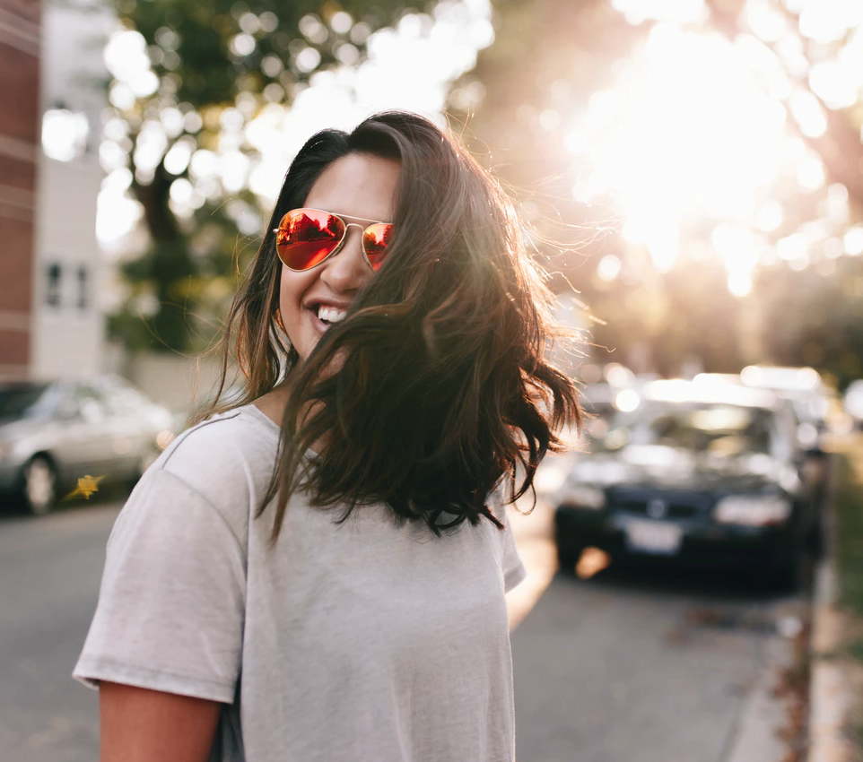 undergraduate grants, woman with red sunglasses standing on street