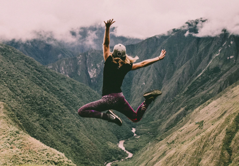 A+ students woman jumping on the trails