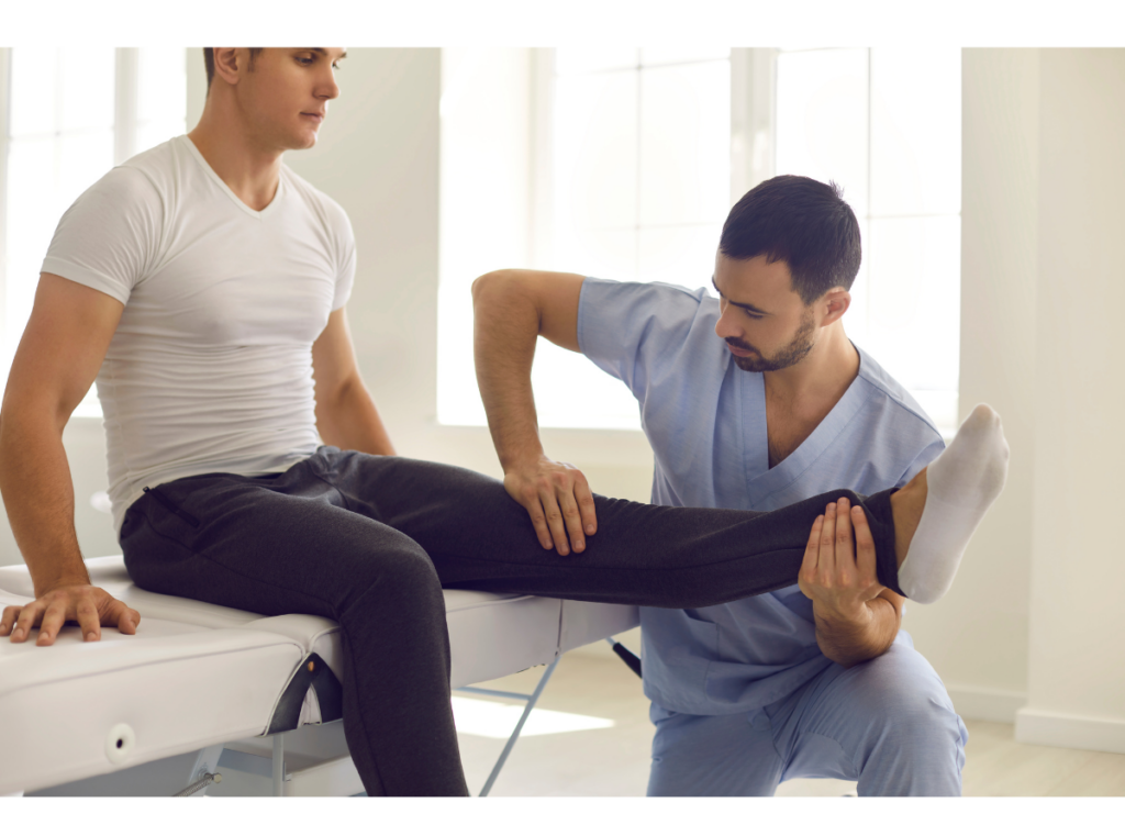 A doctor performs physical therapy on the leg of a male patient
